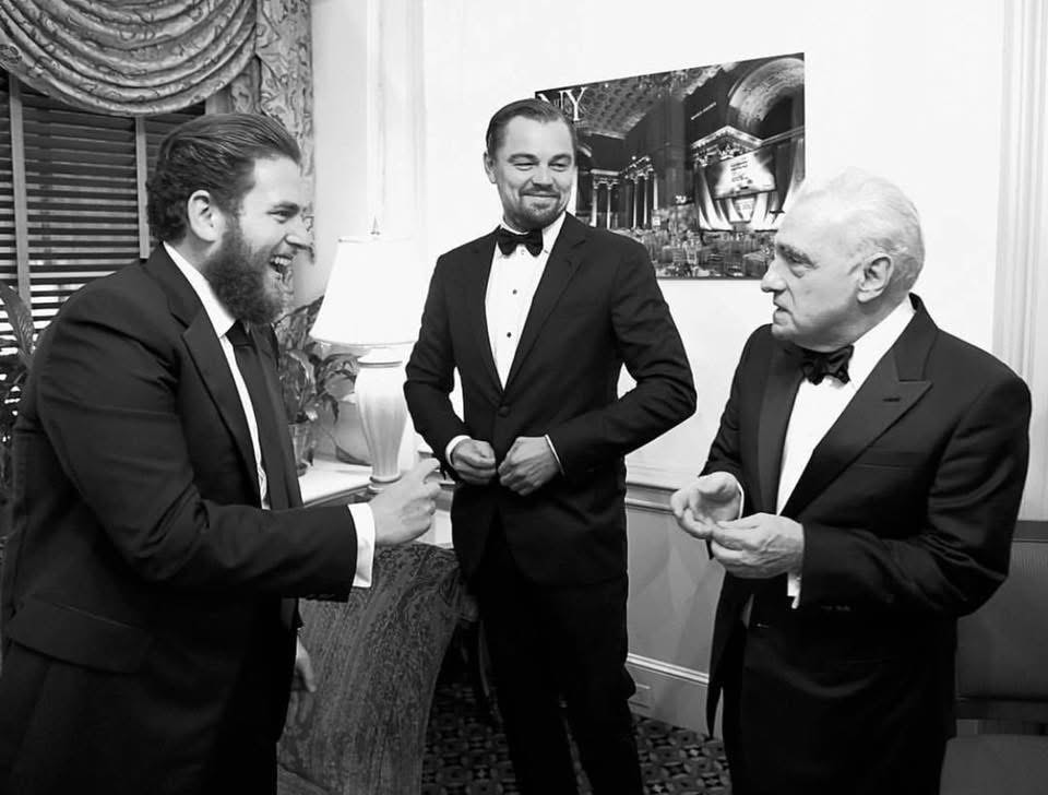 Three men in tuxedos at formal event