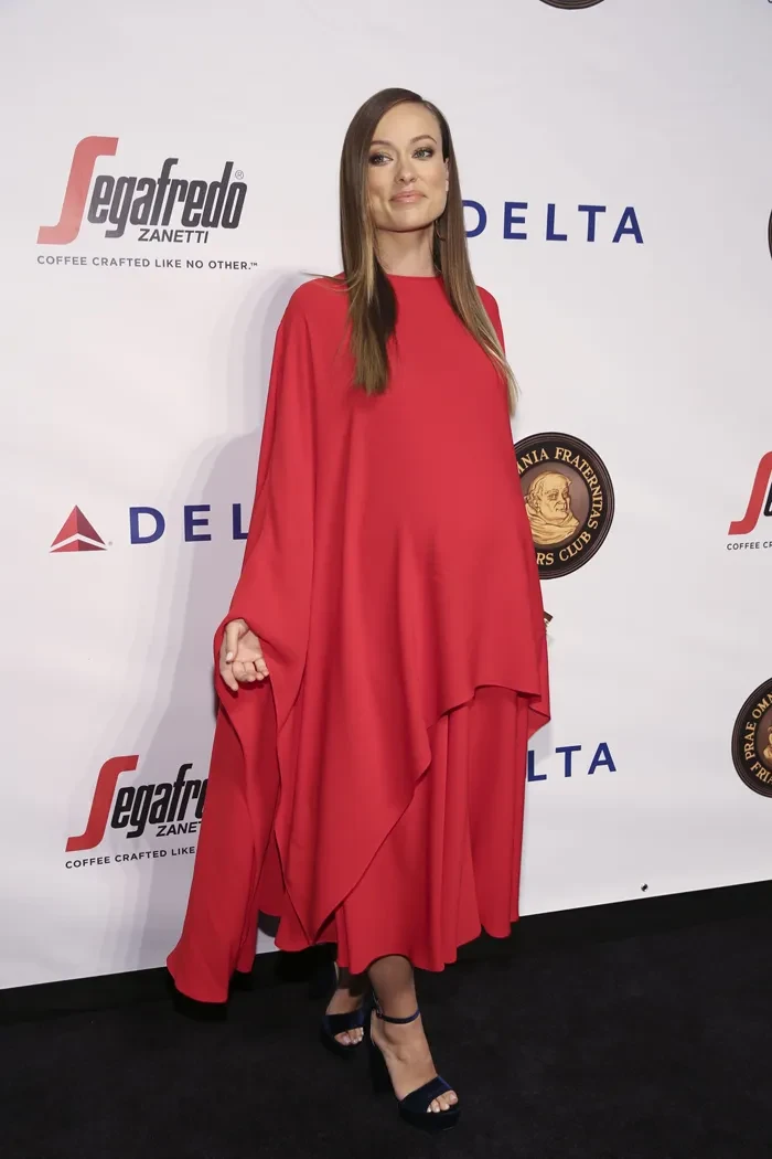 Woman in red cape at event
