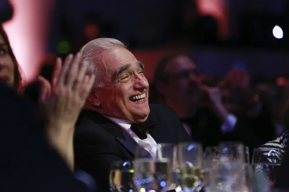 Man in tuxedo laughing at formal event