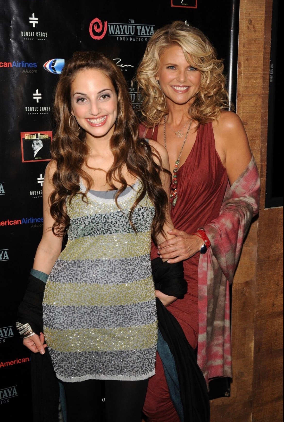 Two women posing at charity event