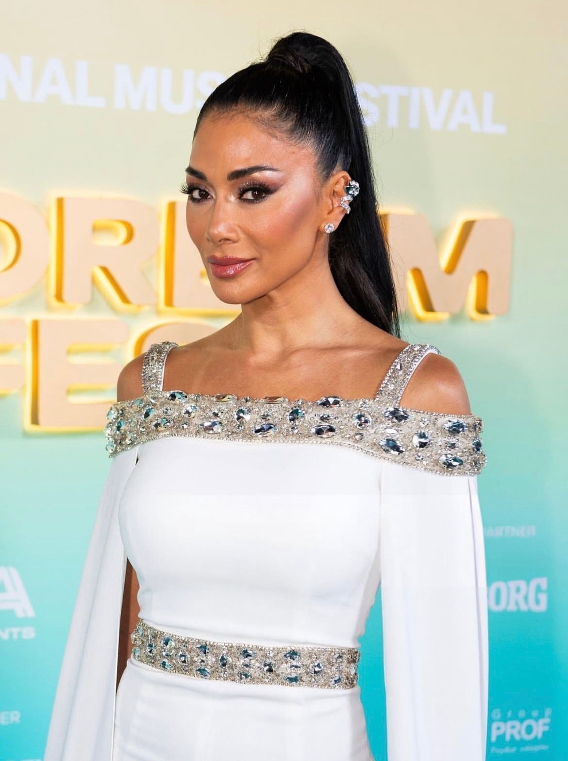 Woman in white embellished gown at festival